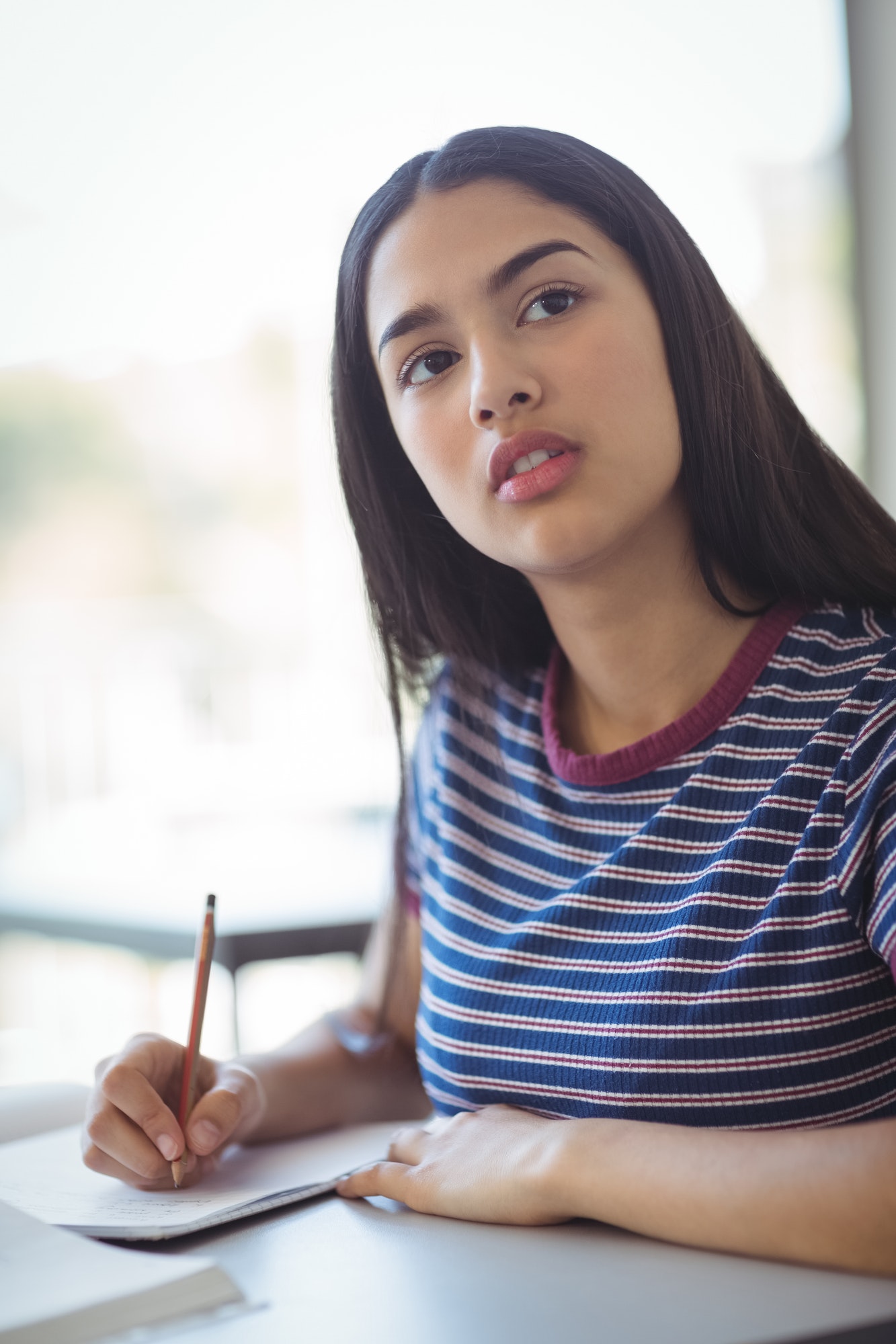 Schoolgirl doing his homework in classroom