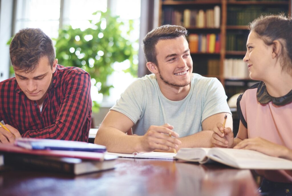 Students learning together in library