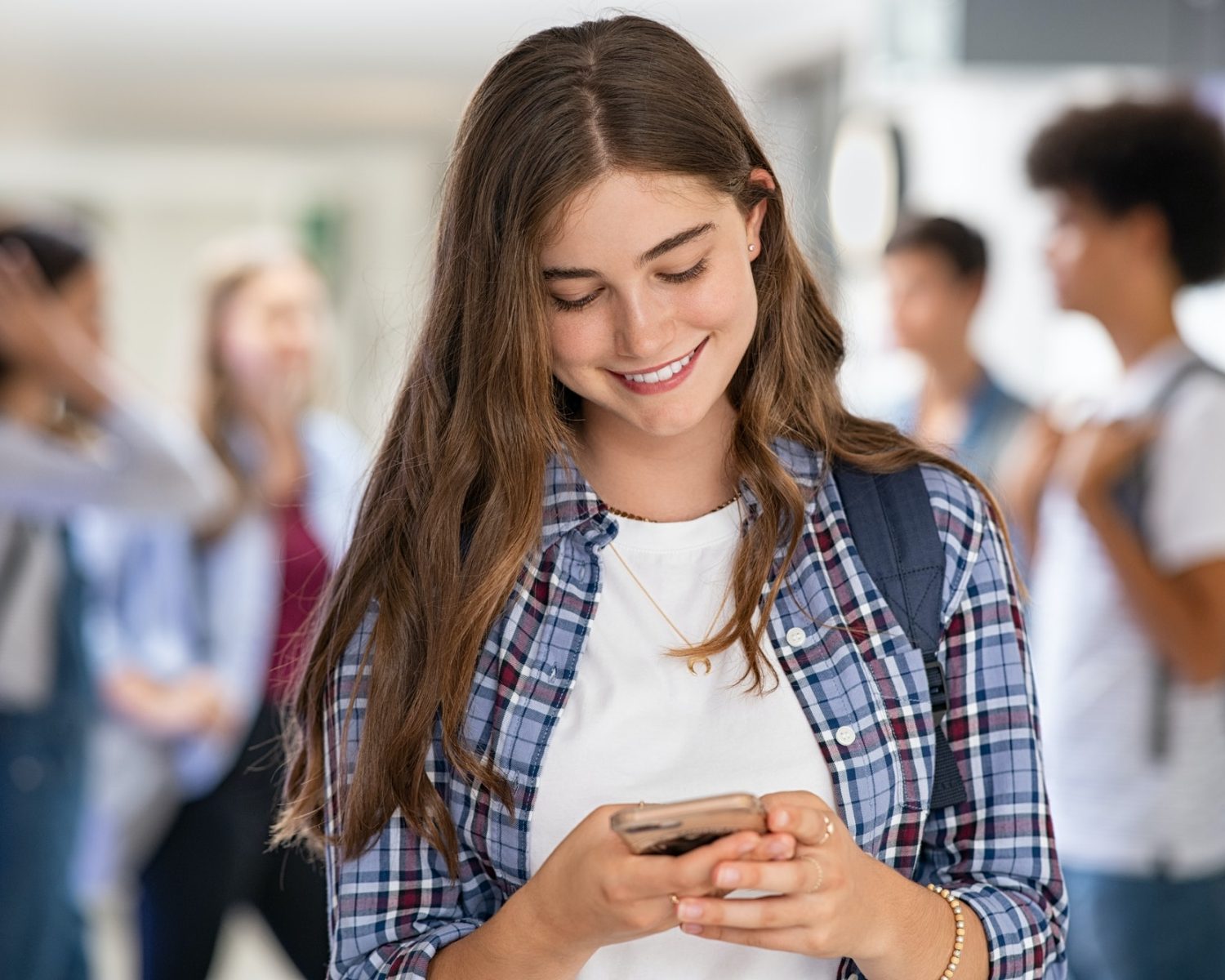 Girl in college school using smartphone